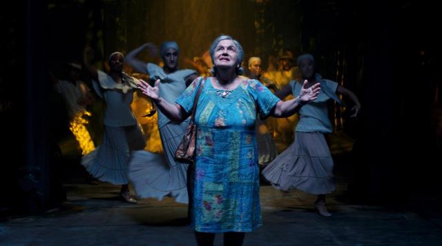 Olga Merediz (center) as Abuela Claudia in director Jon M. Chu’s screen adaptation of “In The Heights.” Cr: Macall Polay/Warner Bros.