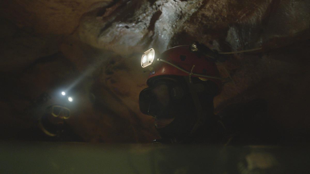 Divers floating in an underwater cave in “The Rescue.” Cr: National Geographic