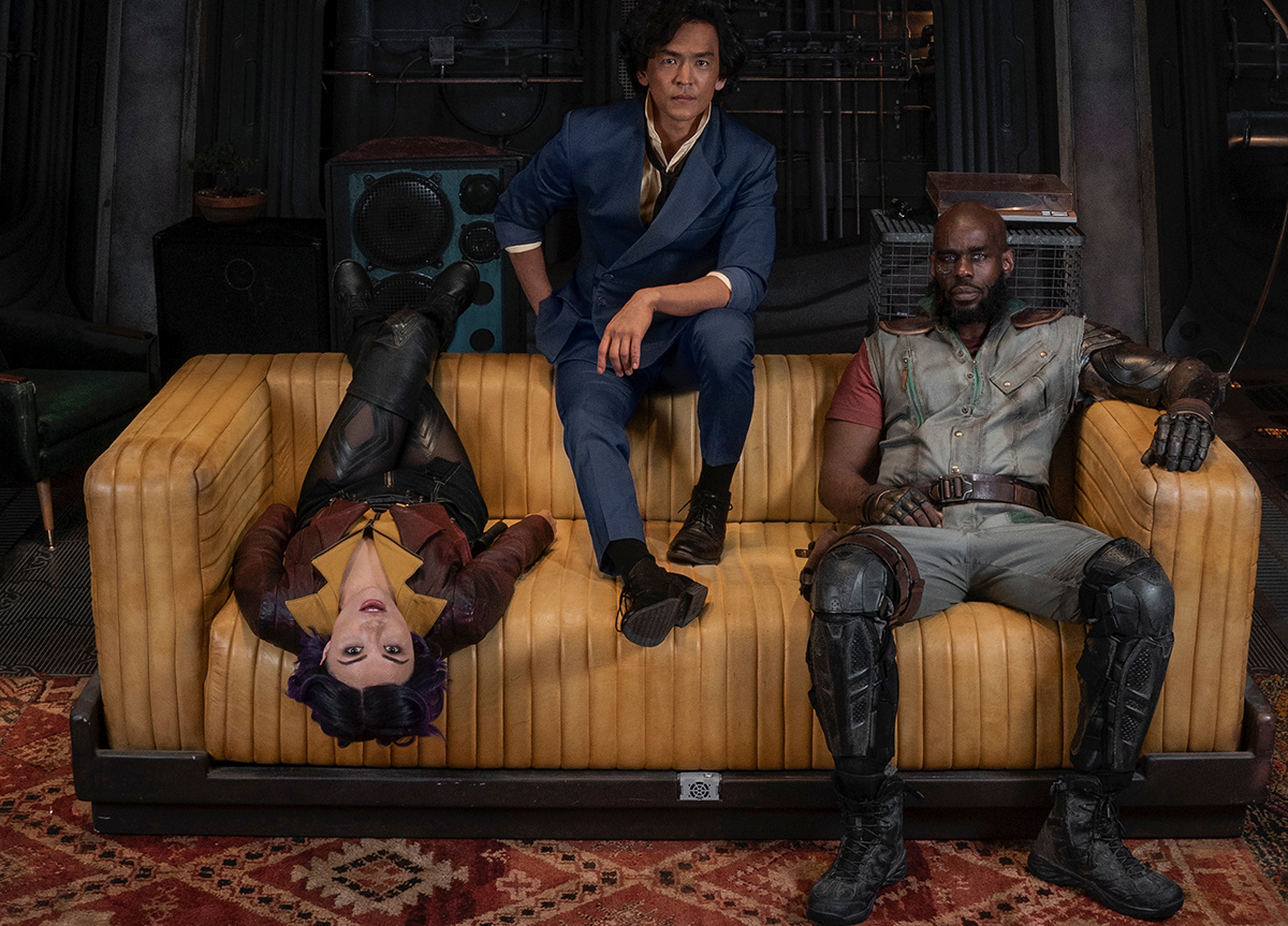 Daniella Pineda as Faye Valentine, John Cho as Spike Spiegel and Mustafa Shakir as Jet Black on the Set of “Cowboy Bepop” Cr. Nicola Dove/Netflix © 2021