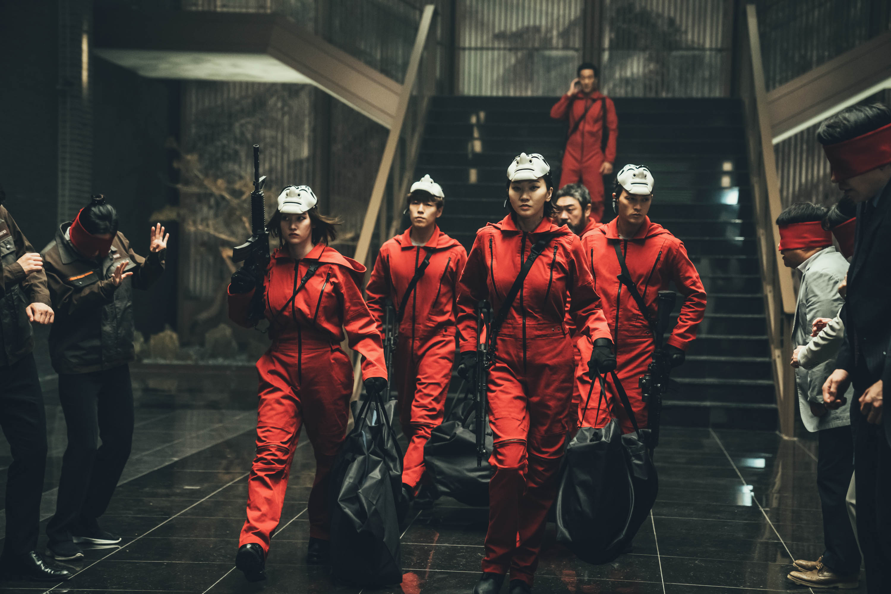 (L to R) Jun Jong-seo as Tokyo, Lee Hyun-woo as Rio, Jang Yoon-ju as Nairobi, Park Hae-soo as Berlin, Lee Won-jong as Moscow and Kim Ji-hun as Denver in “Money Heist Korea: JEA.” Cr. Jung Jaegu/Netflix